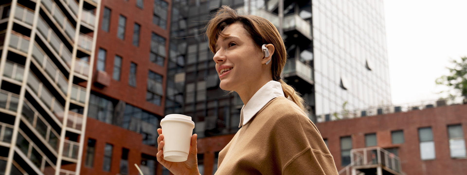 wearing stylish open-ear headphones